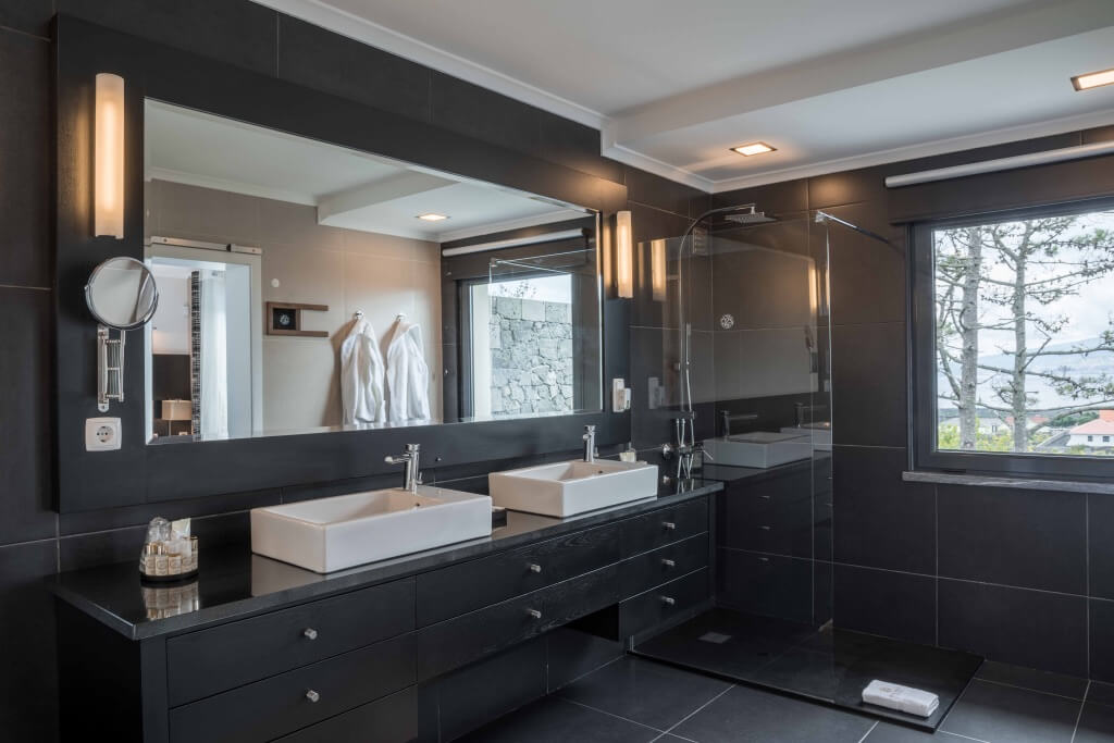 Modern en-suite bathroom with double sinks at the villa